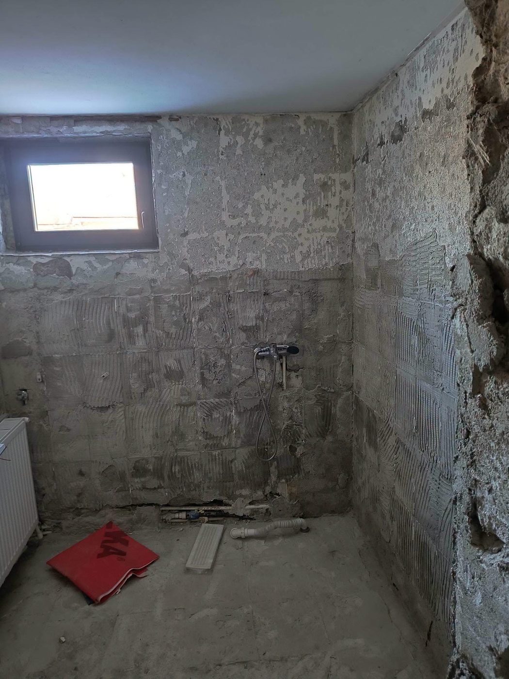 Bathroom stripped back to bare walls and floor before the renovation
